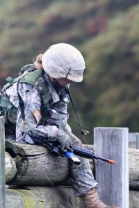 Ranger Challenge Cadet climbs over a wooden barrier