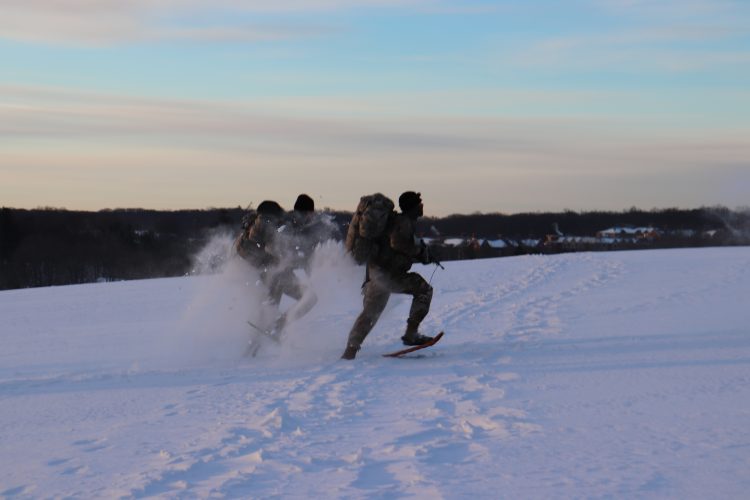 Ranger Challenge cadets sprint in snow shoes on Horsebarn Hill
